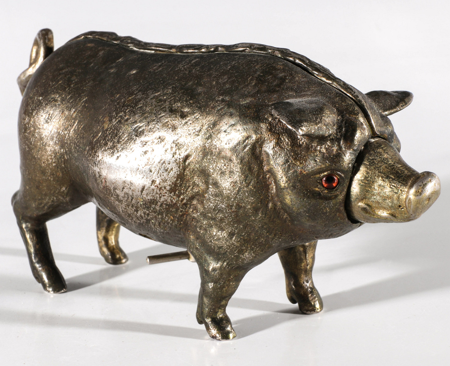 A RARE FIGURAL IRON PIG KEY WIND MECHANICAL DESK BELL