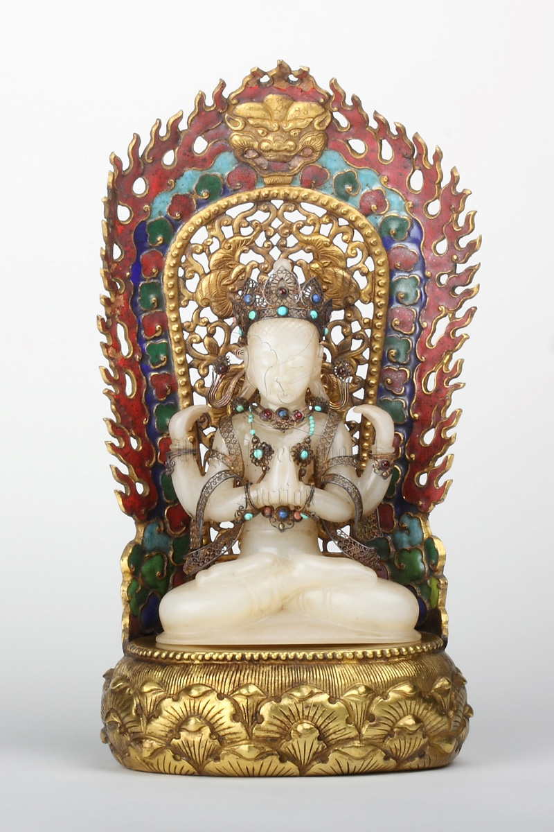 A WHITE JADE BUDDHA WITH GILT-BRONZE MANDORLA