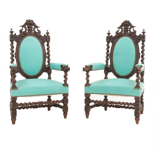 Pair of armchairs France. Twentieth century. In oak wood carving. With closed backrests and padded seats in mint upholstery