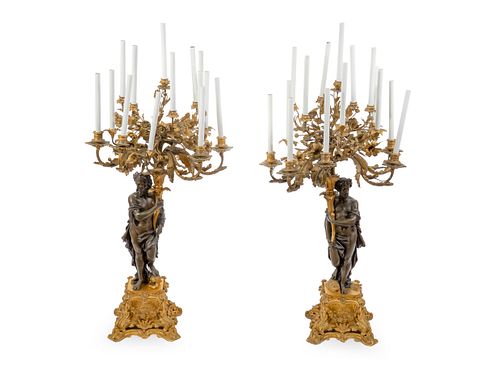 A Pair of Large French Gilt and Patinated Bronze Fourteen-Light Candelabra Height overall 45 inches.