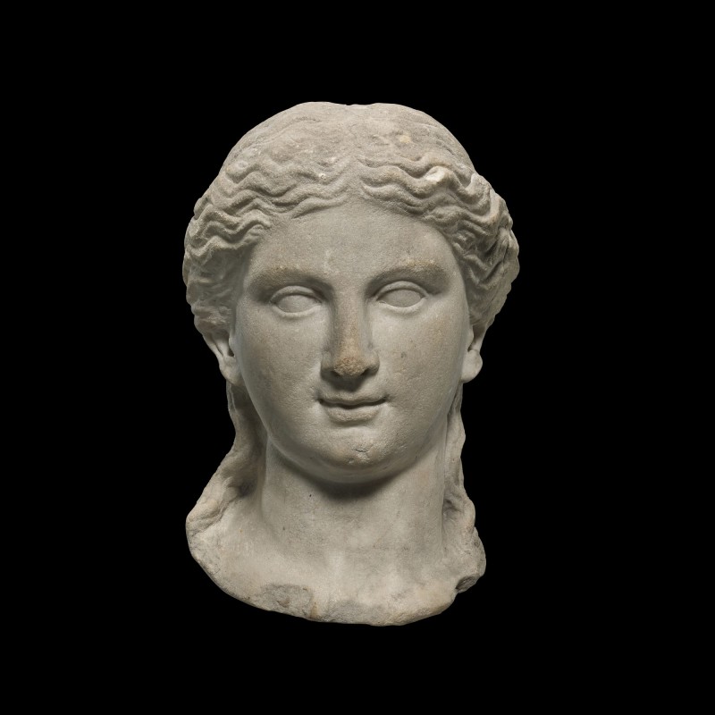 A ROMAN MARBLE HEAD OF A WOMAN, CIRCA EARLY 1ST CENTURY A.D.