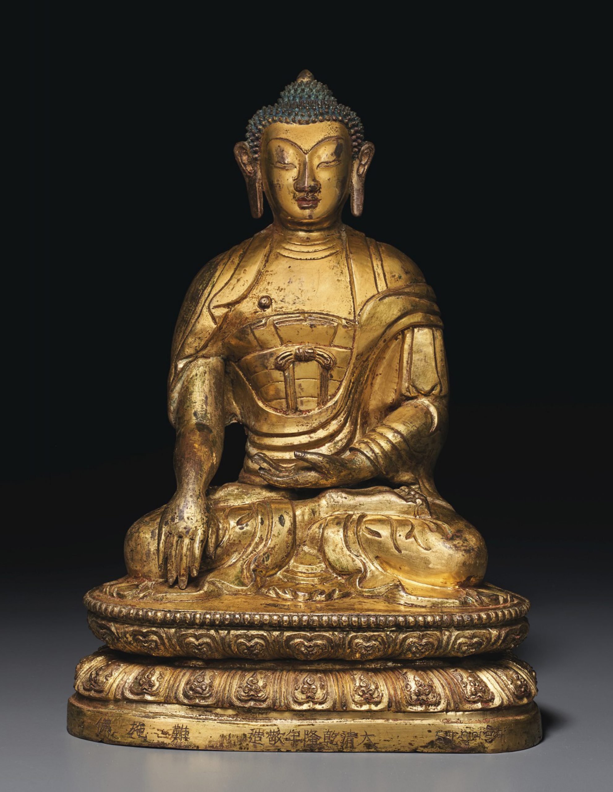 A GILT REPOUSSÉ BRONZE FIGURE OF BUDDHA