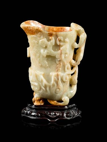 A Russet and Pale Celadon Jade 'Chilong' Rhyton Cup Height 5 3-4 in., 14.6 cm.