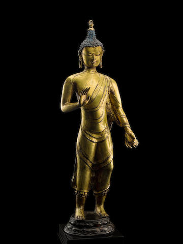 A GILT COPPER ALLOY FIGURE OF STANDING BUDDHA