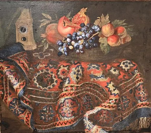 In the Manner of Giuseppe Recco Italian, 1634 - 1695 still life with grapes, pomegranates, an oriental rug, and a clock oil on canvas Gustave White 19